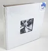 A white photo album with a square cutout showing a black and white image of a flower bud. Podgląd zdjęcia produktu