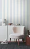 A stylish interior scene with a striped wallpaper, a white cabinet, and a fluffy chair. Produktbild-Vorschau