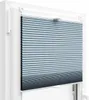 A close-up view of a blue pleated blind installed in a white window frame. Produktbild-Vorschau