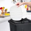 A hand is shown lifting the white lid of a black dual trash can in a kitchen setting. Anteprima dell’immagine prodotto