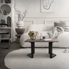 A living room scene with a couch, coffee table, and decorative items. Náhľad obrázku produktu