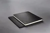 Two black notebooks are stacked on a gray surface. The top notebook has the year "2026" embossed on its cover. Podgląd zdjęcia produktu