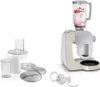 A kitchen appliance set including a stand mixer with a blender attachment, a food processor attachment, and various blades and cups, displayed against a white background. Produktbild-Vorschau