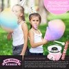 Two young girls wearing party hats are enjoying cotton candy at an outdoor party. A pink cotton candy machine is also shown in the image. Produktbild-Vorschau