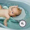A baby is taking a bath in a bathtub, with a thermometer floating in the water. Náhľad obrázku produktu