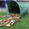 A green leaf collection bag is shown on a lawn with fallen leaves being raked into it. Náhľad obrázku produktu