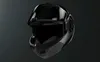 A black motorcycle helmet is shown against a dark background. Voir les images du produit