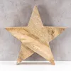 A wooden star decoration is placed on a grey textured background and a white surface. Produktbild-Vorschau