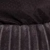 A close-up view of the bottom of a dog bed, showing the textured fabric and the non-slip dots on the underside. Produktbild-Vorschau