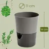 A self-watering pot with herbs depicted in the background. Produktbild-Vorschau