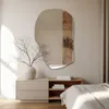 A bedroom scene with a dresser, a mirror, and a bed. Produktbild-Vorschau
