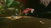 Two toy cars racing on a dirt track in a jungle environment. Produktbild-Vorschau