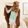 A person wearing a capybara plush costume, holding a brown blanket. Podgląd zdjęcia produktu