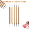 A set of dotting tools and a hand using one to decorate a pink object. Produktbild-Vorschau