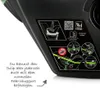 Close-up of a black car seat base with instructional diagrams and German text. Anteprima dell’immagine prodotto