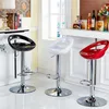 Three bar stools in black, white, and red are arranged in a modern kitchen or bar area. Produktbild-Vorschau