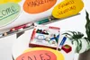 A collection of STABILO markers and pencils are displayed on a white surface, with colorful oval-shaped signs in the background. Voir les images du produit
