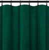 A close-up view of dark green velour curtains hanging from a black curtain rod. Podgląd zdjęcia produktu
