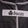 A close-up view of a black horse blanket with a grey strap and the Bucas logo. Produktbild-Vorschau
