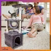 A family is relaxing in a living room with a cat tree and a cat. Náhľad obrázku produktu