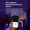 A hand holding a smartphone near a studio light, demonstrating NFC pairing. Náhled obrázku produktu