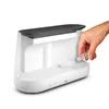 A hand is pouring liquid from a small bottle into a white humidifier. Produktbild-Vorschau
