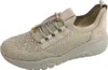 A single beige sneaker with gold accents is shown against a white background. Produktbild-Vorschau