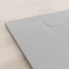 A close-up view of a gray shower tray on a light wooden floor. Produktbild-Vorschau