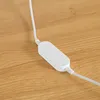 A close-up shot of a white electronic device with a cable on a wooden surface. Anteprima dell’immagine prodotto