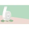 A roll of white label paper is shown on a reflective surface against a pastel background. Podgląd zdjęcia produktu