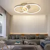 A modern living room with a sectional sofa, coffee table, and a contemporary ceiling light fixture. Podgląd zdjęcia produktu