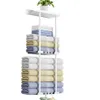 A white towel rack with towels stacked on it, and a small plant on top. Produktbild-Vorschau