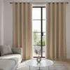 A living room scene with curtains covering a window and a sofa in the foreground. Podgląd zdjęcia produktu