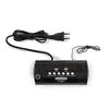 A black digital alarm clock with a power cord and plug is shown against a white background. Náhled obrázku produktu