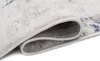 A close-up view of a rolled-up rug, showing the texture and edge. Náhled obrázku produktu