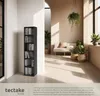 A modern living room with a tall black shelf filled with CDs, DVDs, and books, next to a sofa and plants. Produktbild-Vorschau