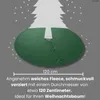 A green Christmas tree skirt is shown under a stylized Christmas tree with decorative stars around it. Náhľad obrázku produktu