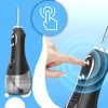 A hand is shown pressing a button on a water flosser, with a graphic indicating touch control. Voir les images du produit