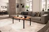 A modern living room with a sectional sofa, coffee table, and a view into a kitchen area. Produktbild-Vorschau
