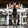 A man is performing a pull-up exercise with a weight belt attached to his waist. Náhľad obrázku produktu