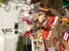 Christmas cookies in gift bags on a wooden table with other festive items. Produktbild-Vorschau