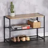 A shoe rack with shoes, books, and a plant. Náhled obrázku produktu