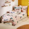 A child's bed with bedding featuring a sloth and palm tree pattern. Produktbild-Vorschau