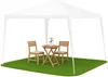 A white gazebo with a small wooden table and two chairs set up on a patch of grass. Náhled obrázku produktu
