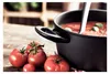 A pot of tomato soup with fresh tomatoes on a wooden surface. Náhled obrázku produktu