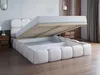 A white upholstered bed with its storage compartment open, revealing the wooden slatted base and storage space. Produktbild-Vorschau