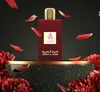 A bottle of perfume is displayed on a pedestal, surrounded by falling rose petals and flowers. Náhled obrázku produktu