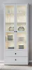 A white display cabinet with glass doors, illuminated shelves, and two drawers at the bottom. Produktbild-Vorschau