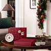 A festive Christmas scene with an advent calendar, decorative plates, and mugs on a wooden table. Produktbild-Vorschau