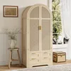 A wooden wardrobe with woven doors and drawers, placed in a room with a window and a stool. Podgląd zdjęcia produktu